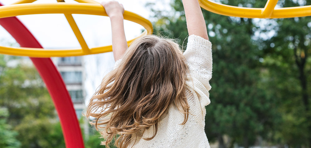 Child on playground by Sarah Pflug